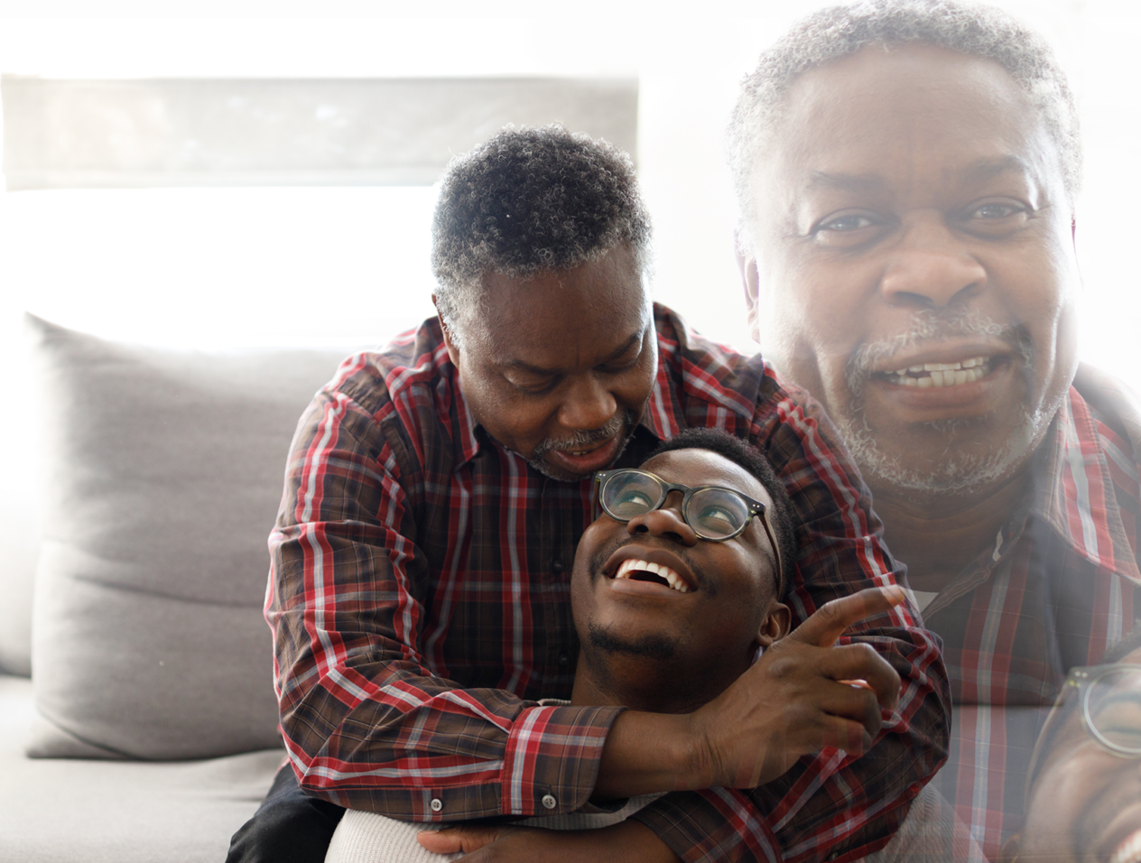 Man hugging his grandson and smiling